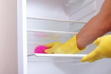 woman cleaning refrigerator