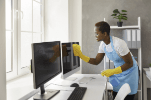 commercial cleaner cleaning a computer screen